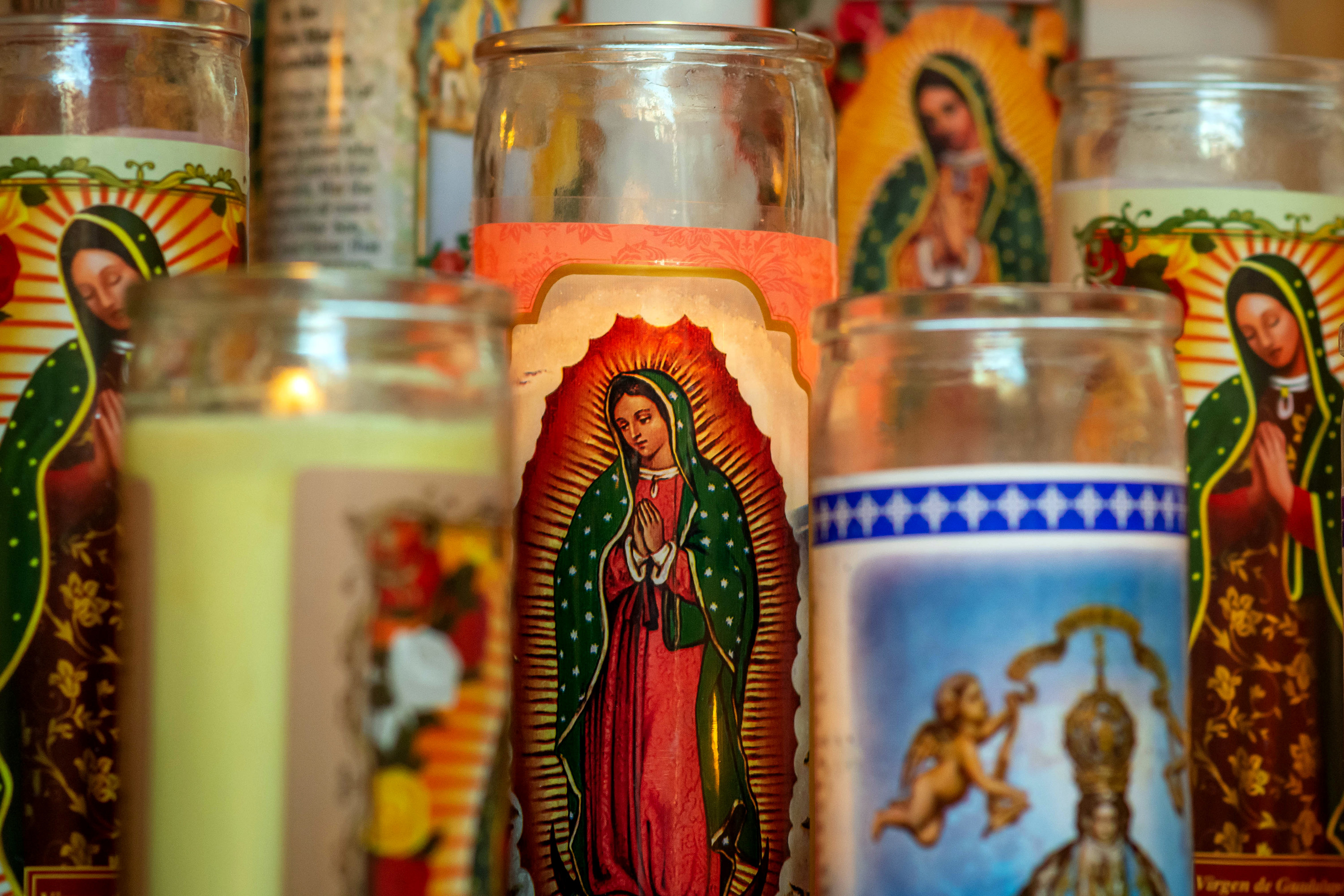 A collection of prayer candles on display at a Catholic shrine