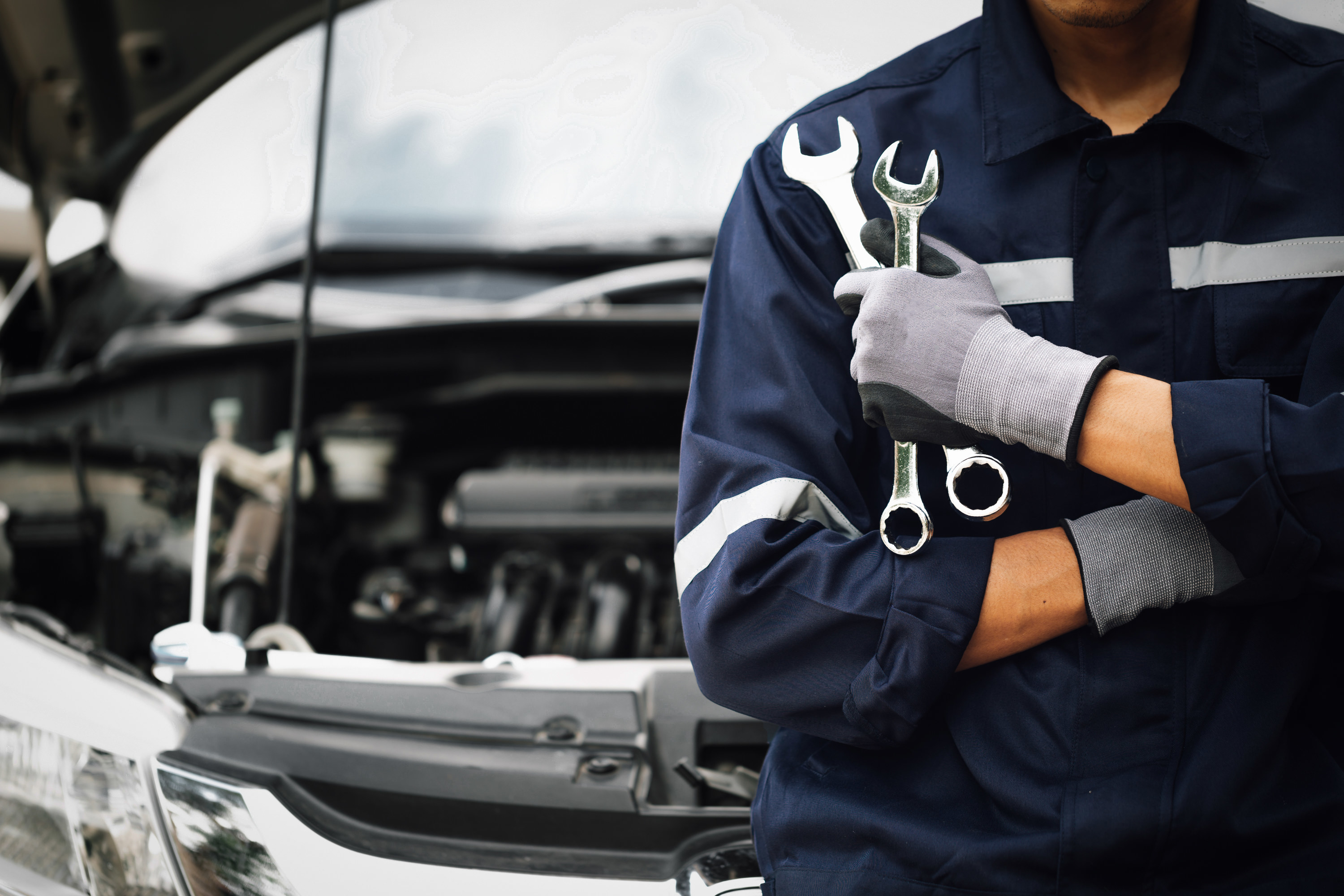 Hand of car mechanic with wrench