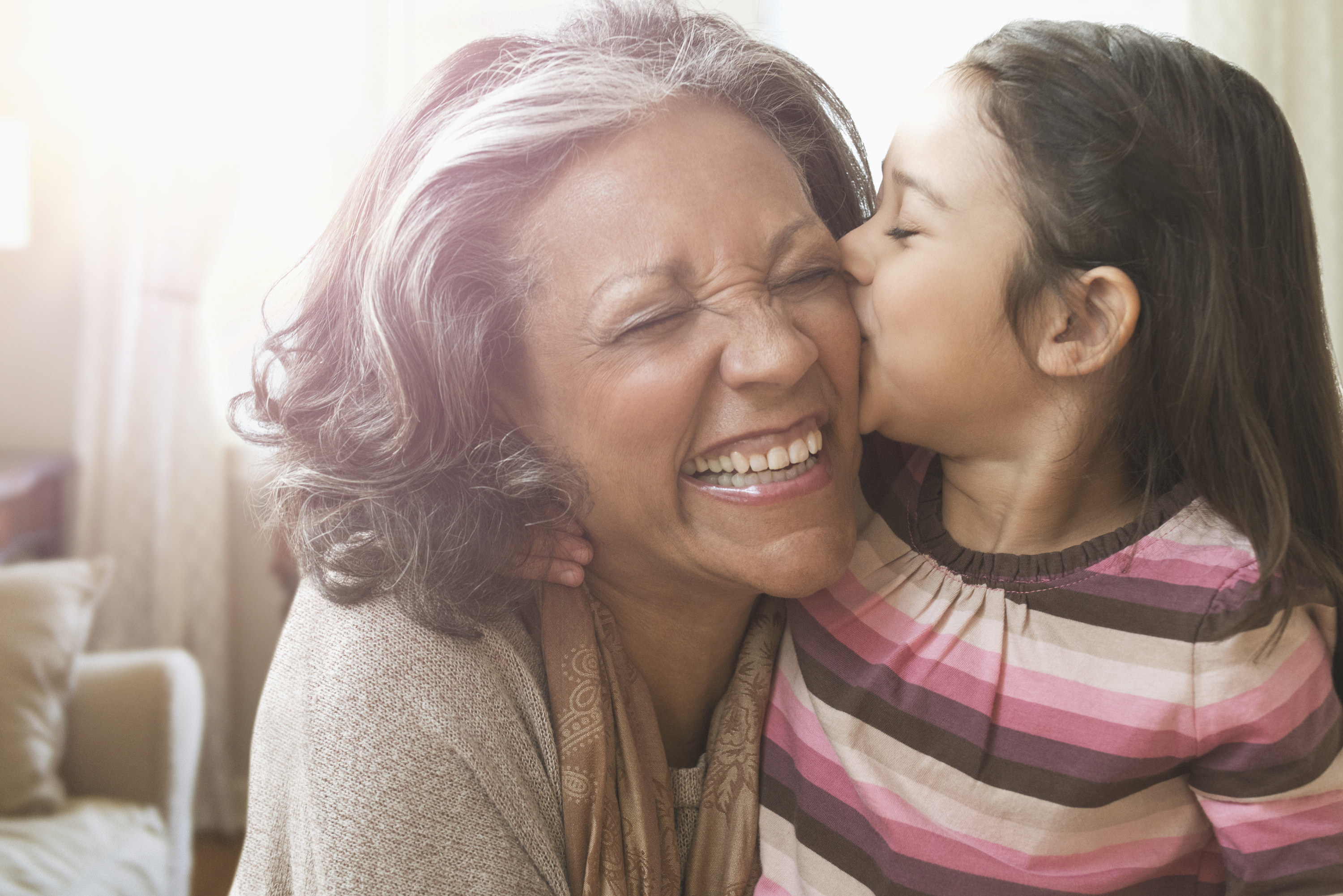 Little girl kissing older woman on the cheek