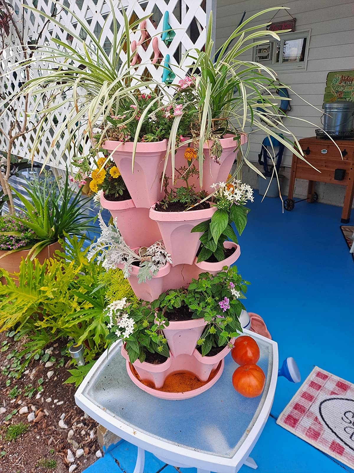 Reviewer photo of the stackable garden in pink with plants in it