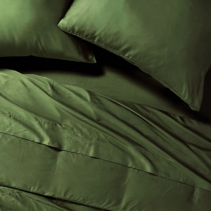 Green eucalyptus sheets and pillows made on bed