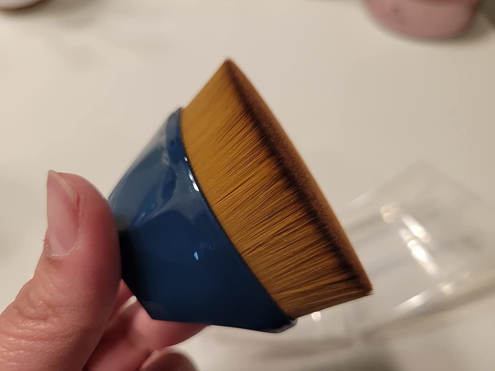 Reviewer holding the blue brush