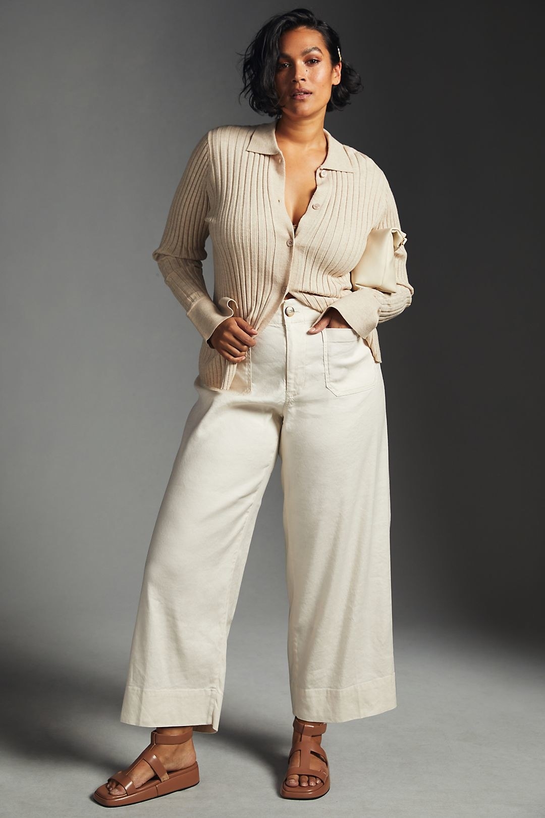 model in high-waisted off-white wide-leg pants
