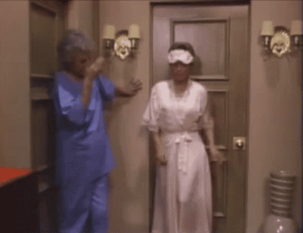 Blanche struts forward in a matching PJ set and eye mask while Dorothy shakes her head (via The Golden Girls)