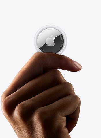 a model holding the airtag