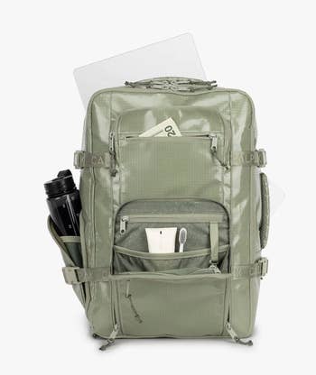 green backpack with pouches open to show storage