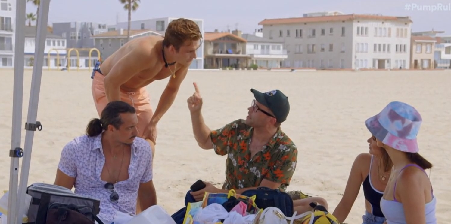 James and Schwartz yelling at each other on a beach