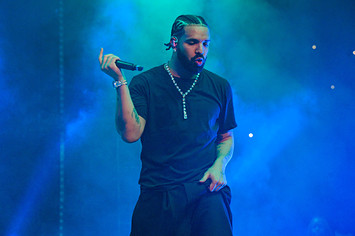 Drake performing live holding microphone