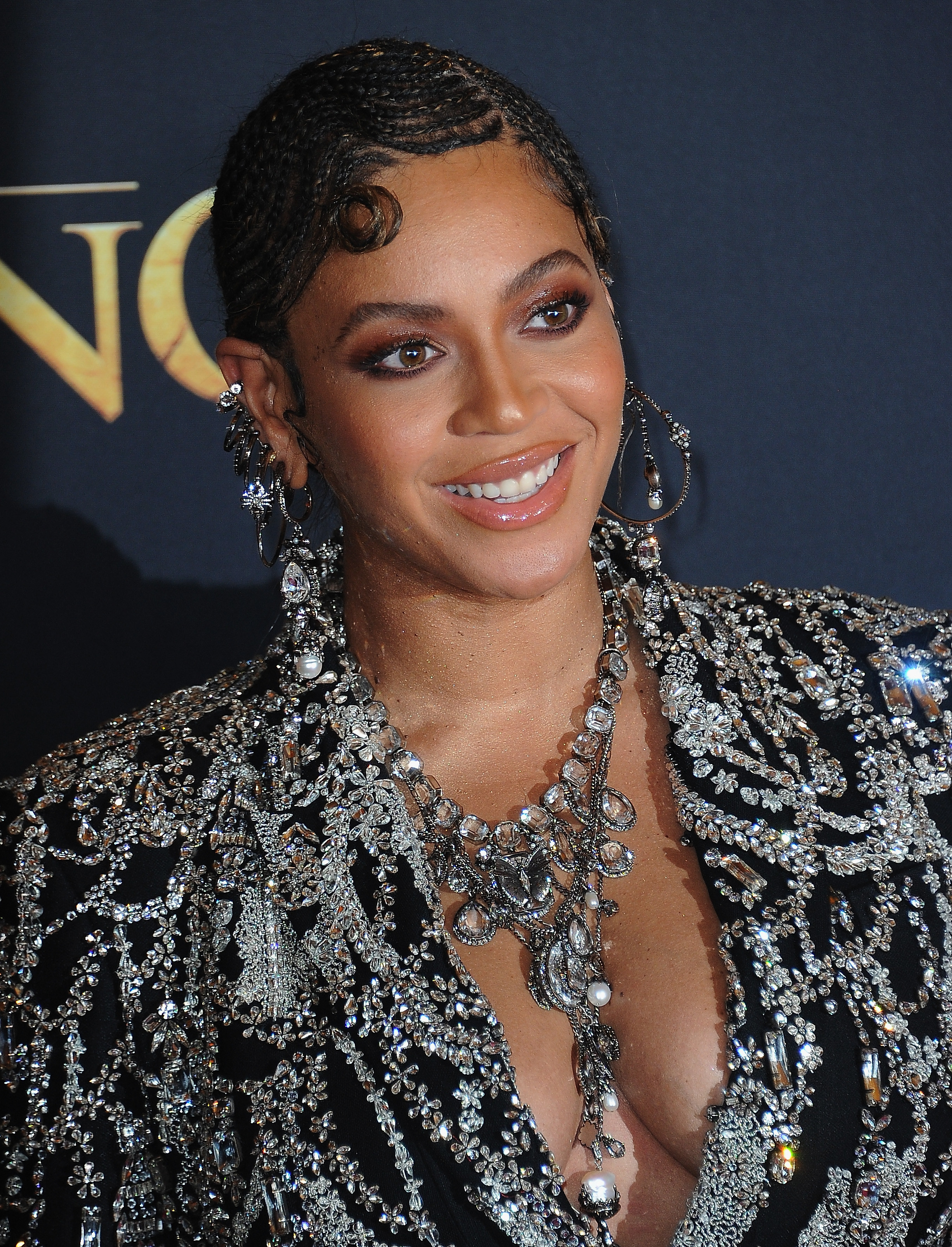 Close-up of Beyoncé smiling in a bejeweled outfit
