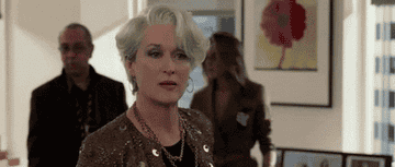 Miranda Priestly looks down in a judging manner at her intern Andy Sachs&#x27; shoe choice