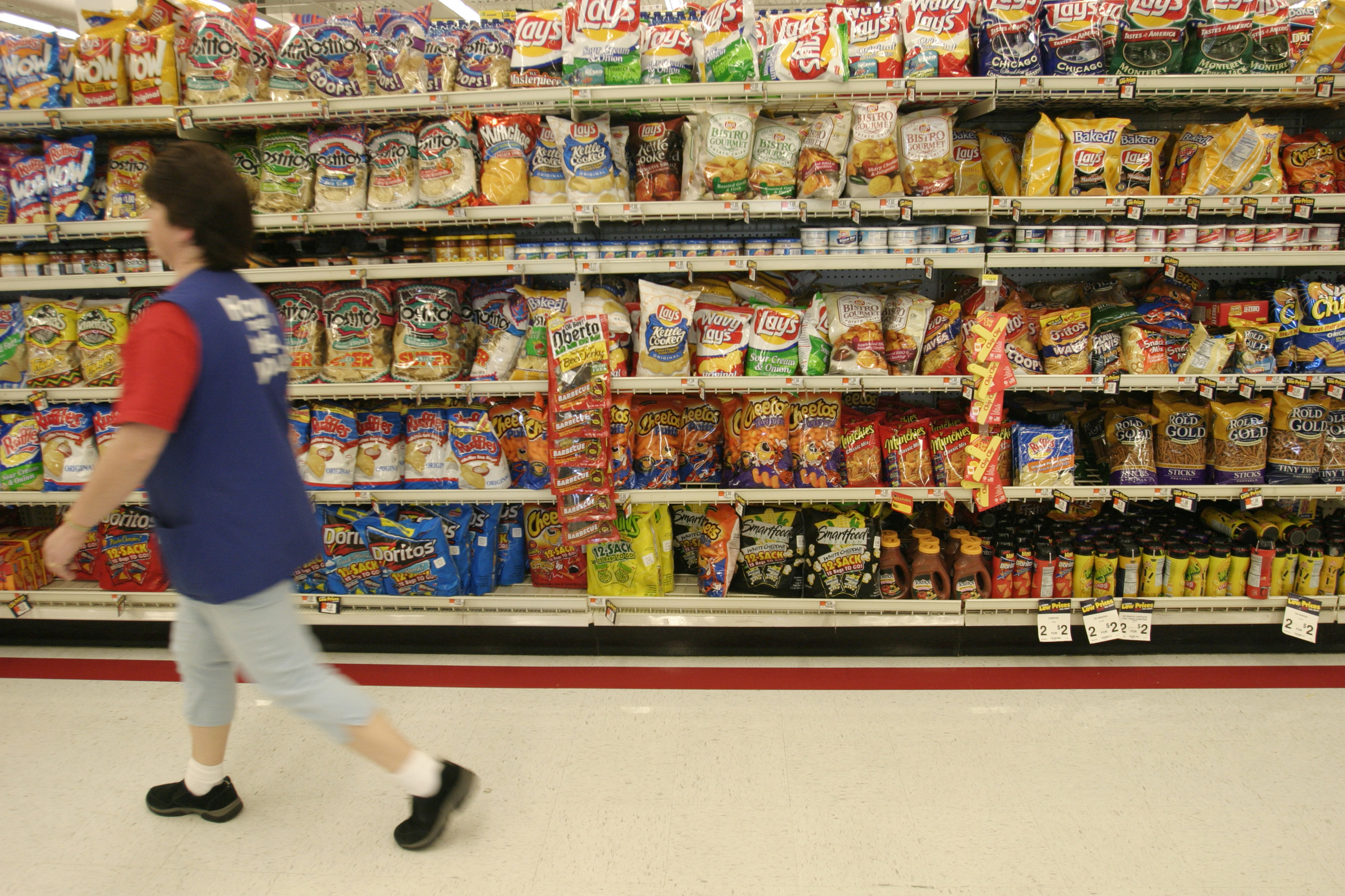Employee walking down the chip aisle in Walmart