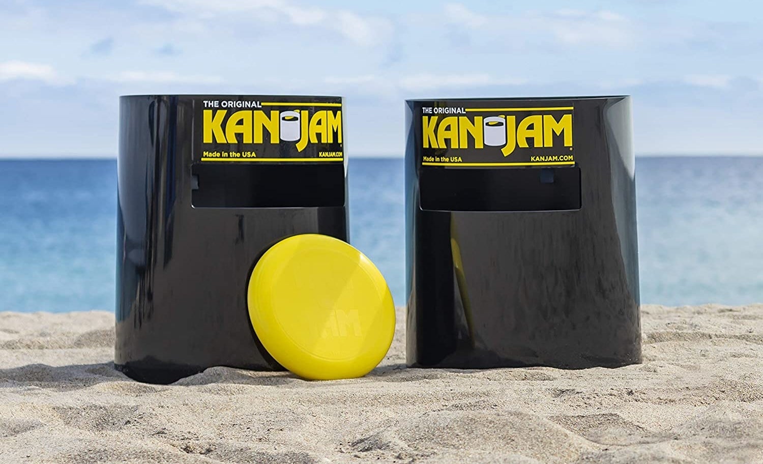 a pair of black plastic tubes with a slot cut out towards the top of it designed so you can throw a frisbee through it. each tube says &quot;kan jam&quot; in yellow letters