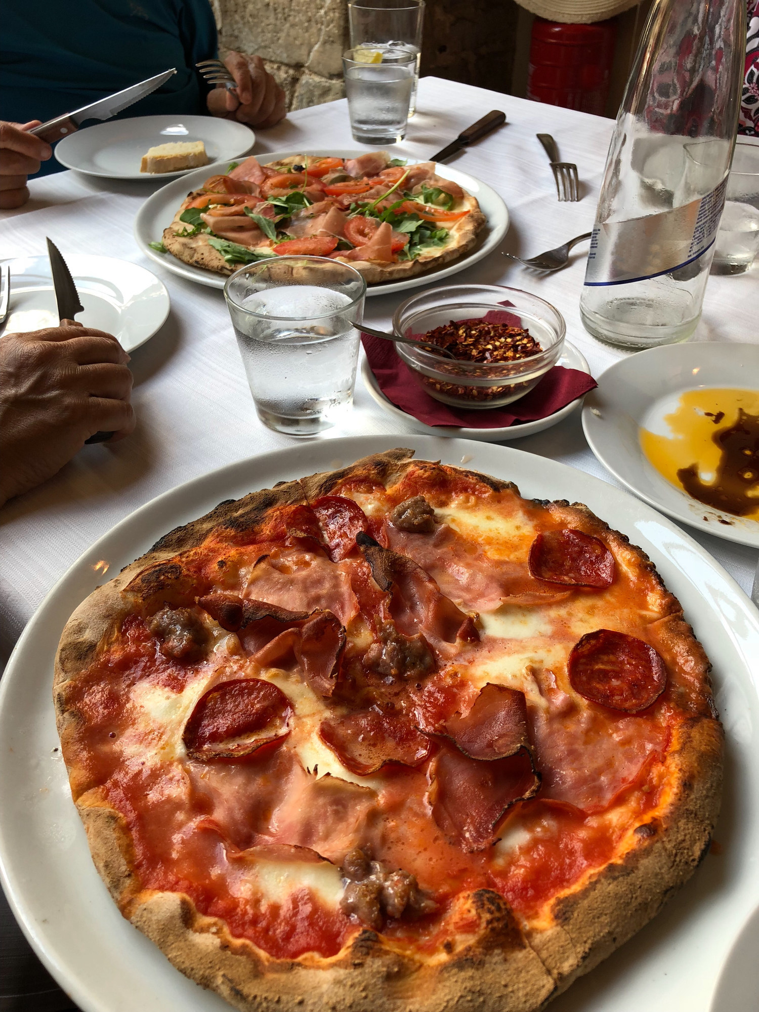 Two pizzas on a table in a restaurant in Italy