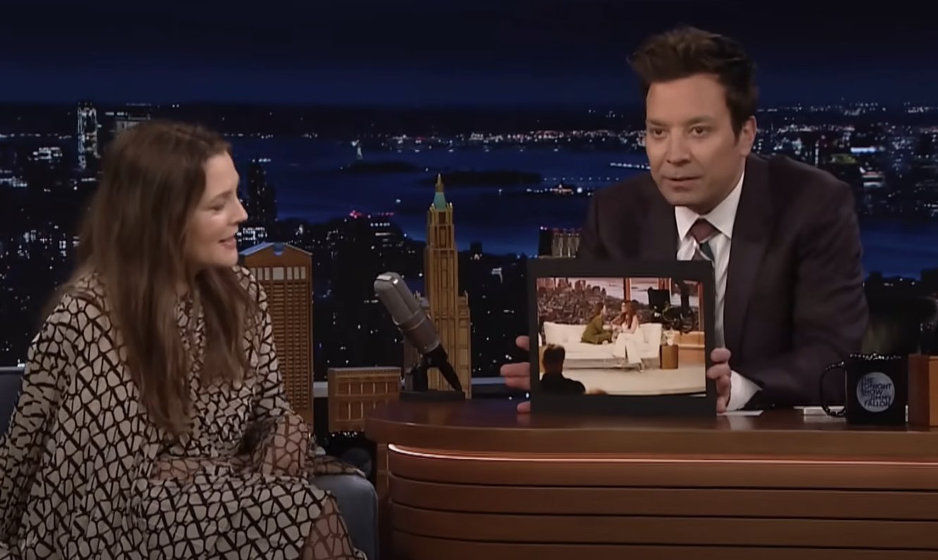 Drew on Jimmy&#x27;s show as he holds up a photo of her and a guest sitting together