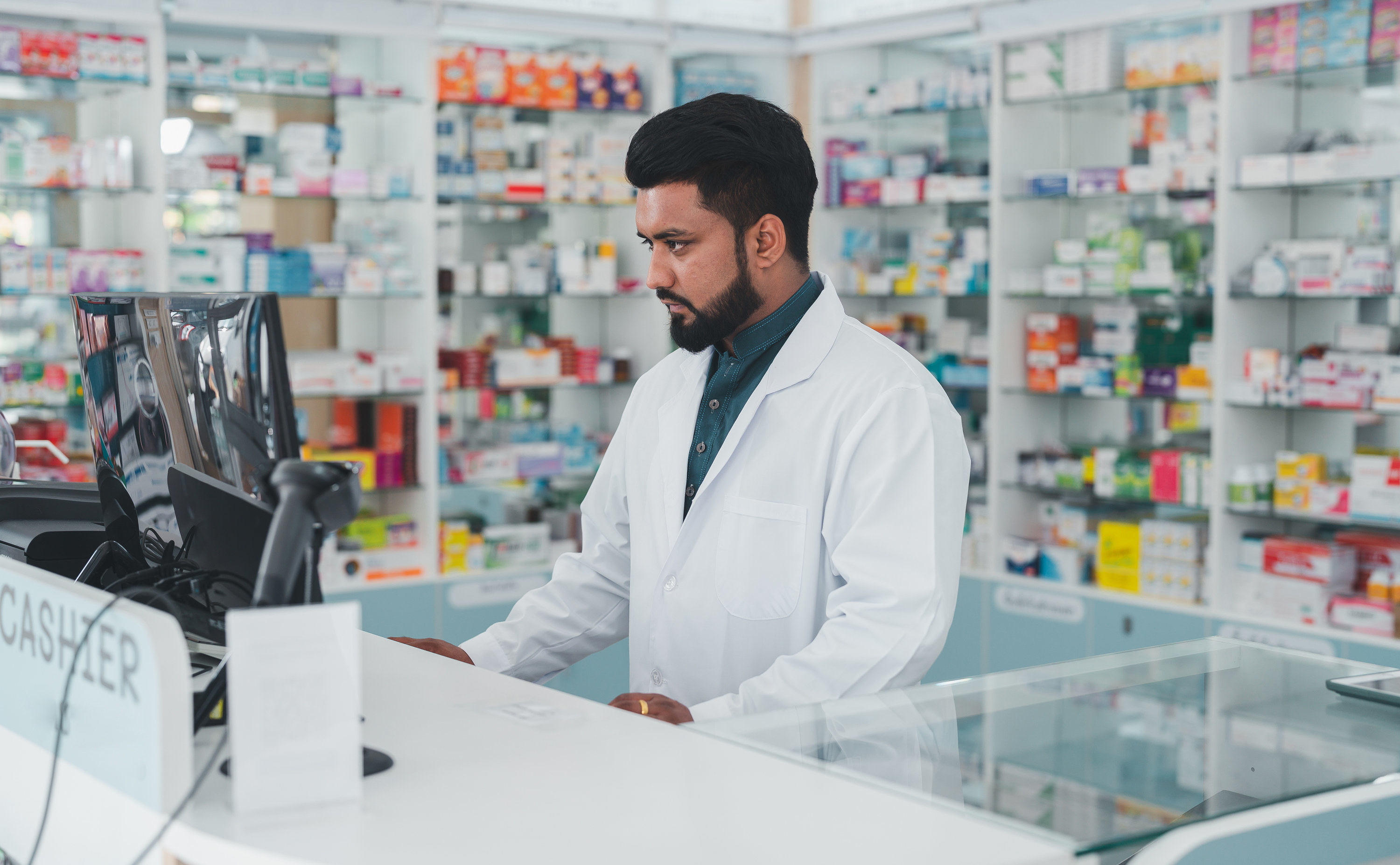 A pharmacist assistant at the cash register