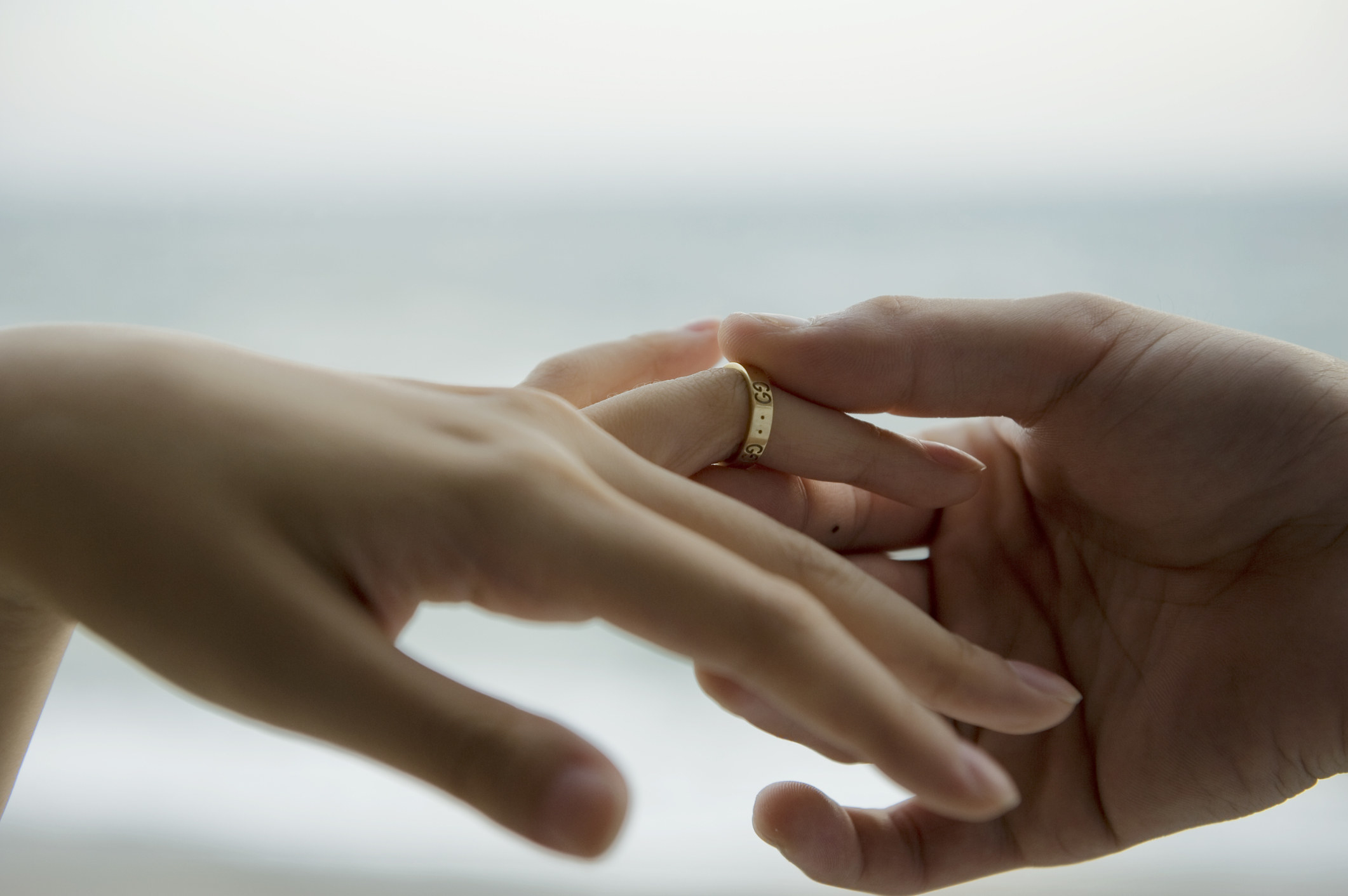 A person putting a ring on another person&#x27;s finger