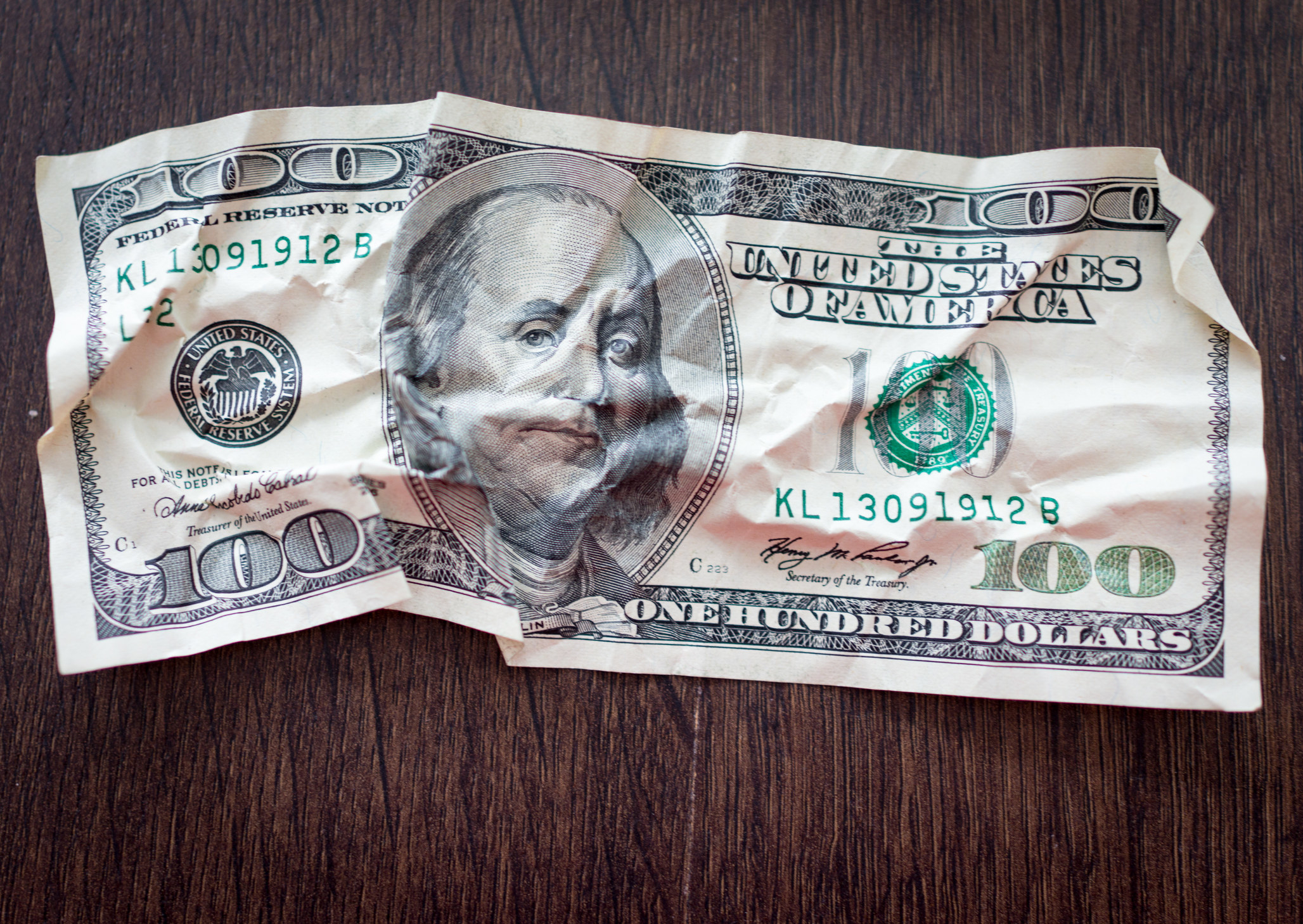 A crumpled $100 bill