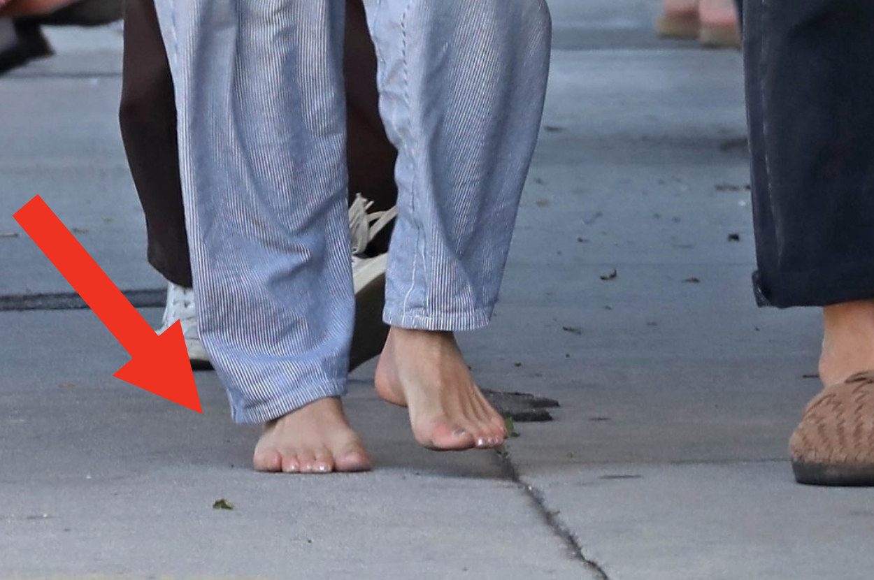 close up on bare feet on sidewalk