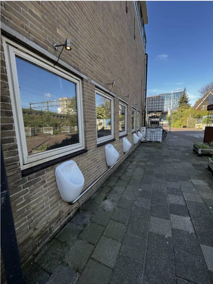Urinals outside on the side of a building