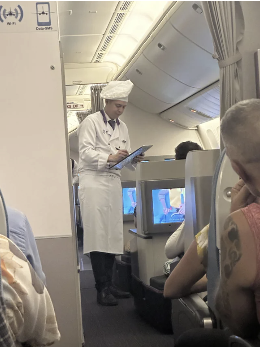 A chef taking someone&#x27;s order on a plane