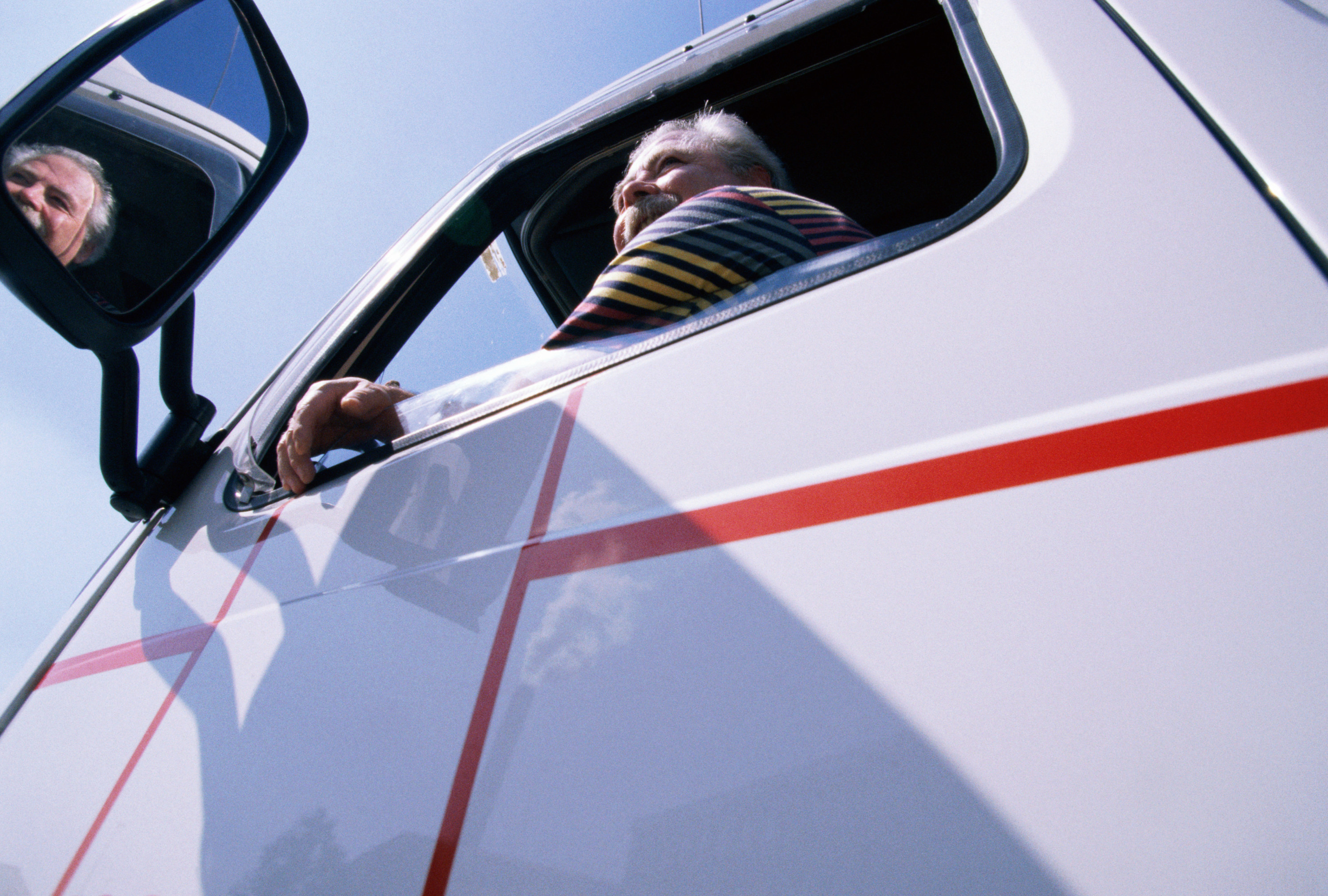 a truck driver sitting in the driver&#x27;s seat