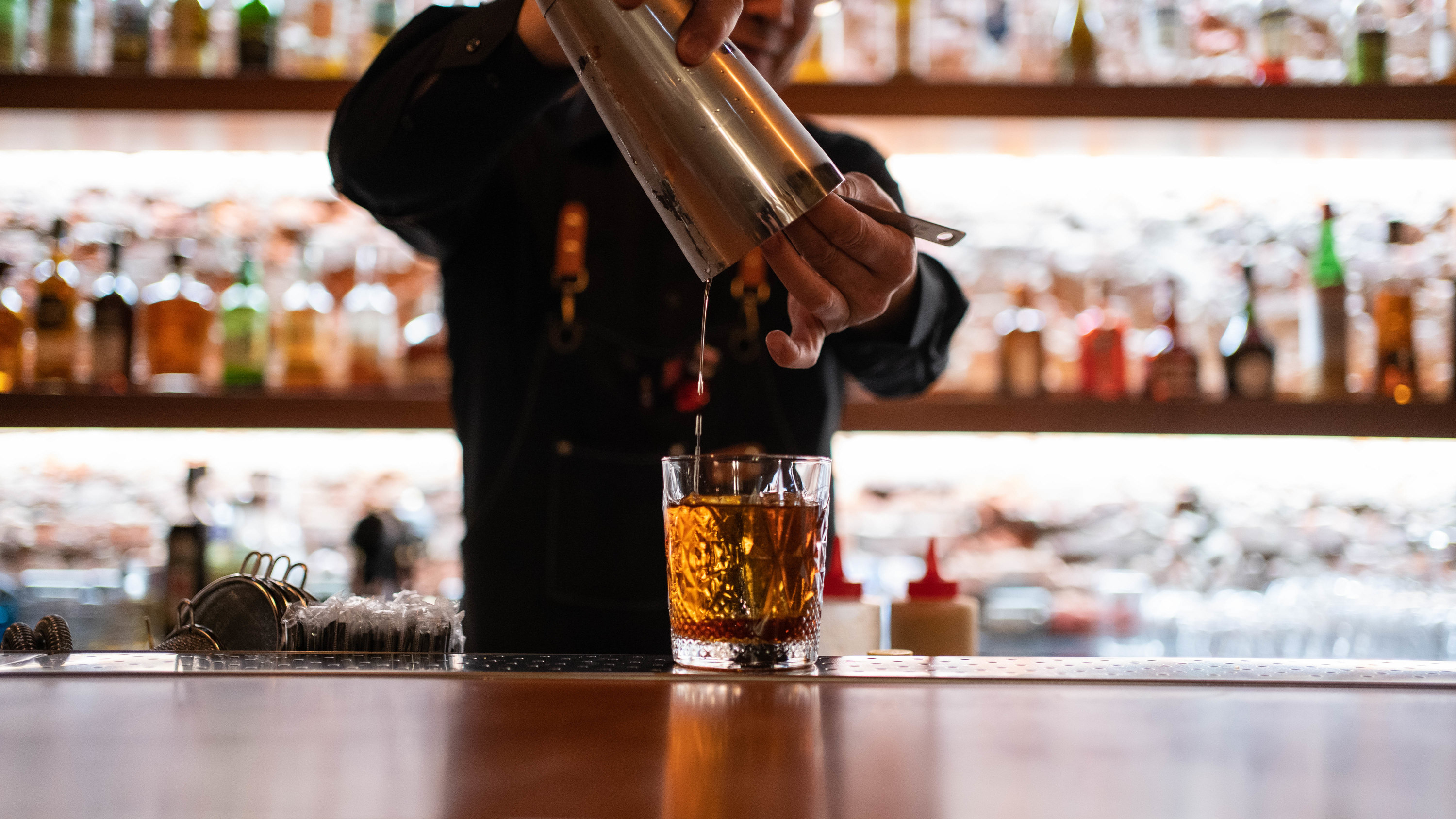 a bartender pouring a drink