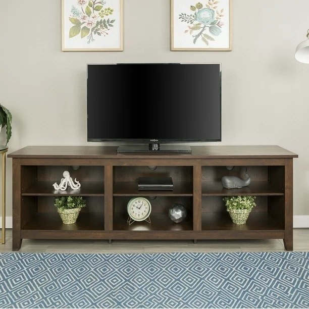 The TV stand with accents and a TV on top