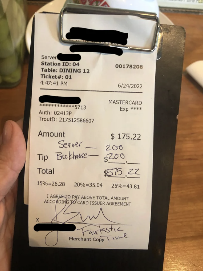 A check with $400 in tips added to a $175 bill
