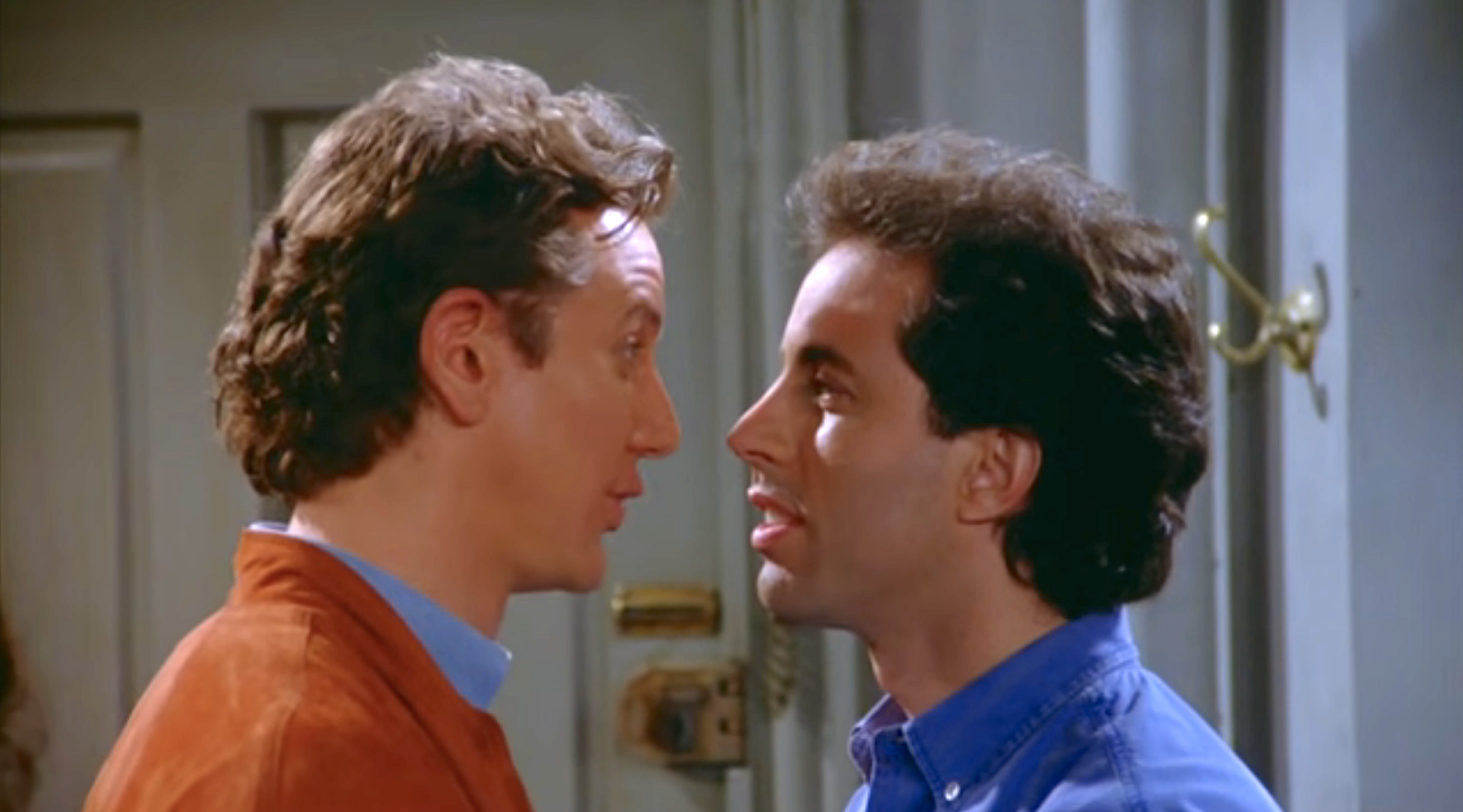 Two men standing very close to each other