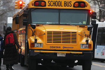Kids being escorted onto school bus