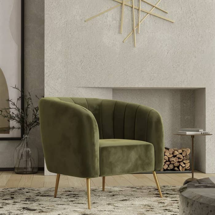 An olive green velvet accent chair