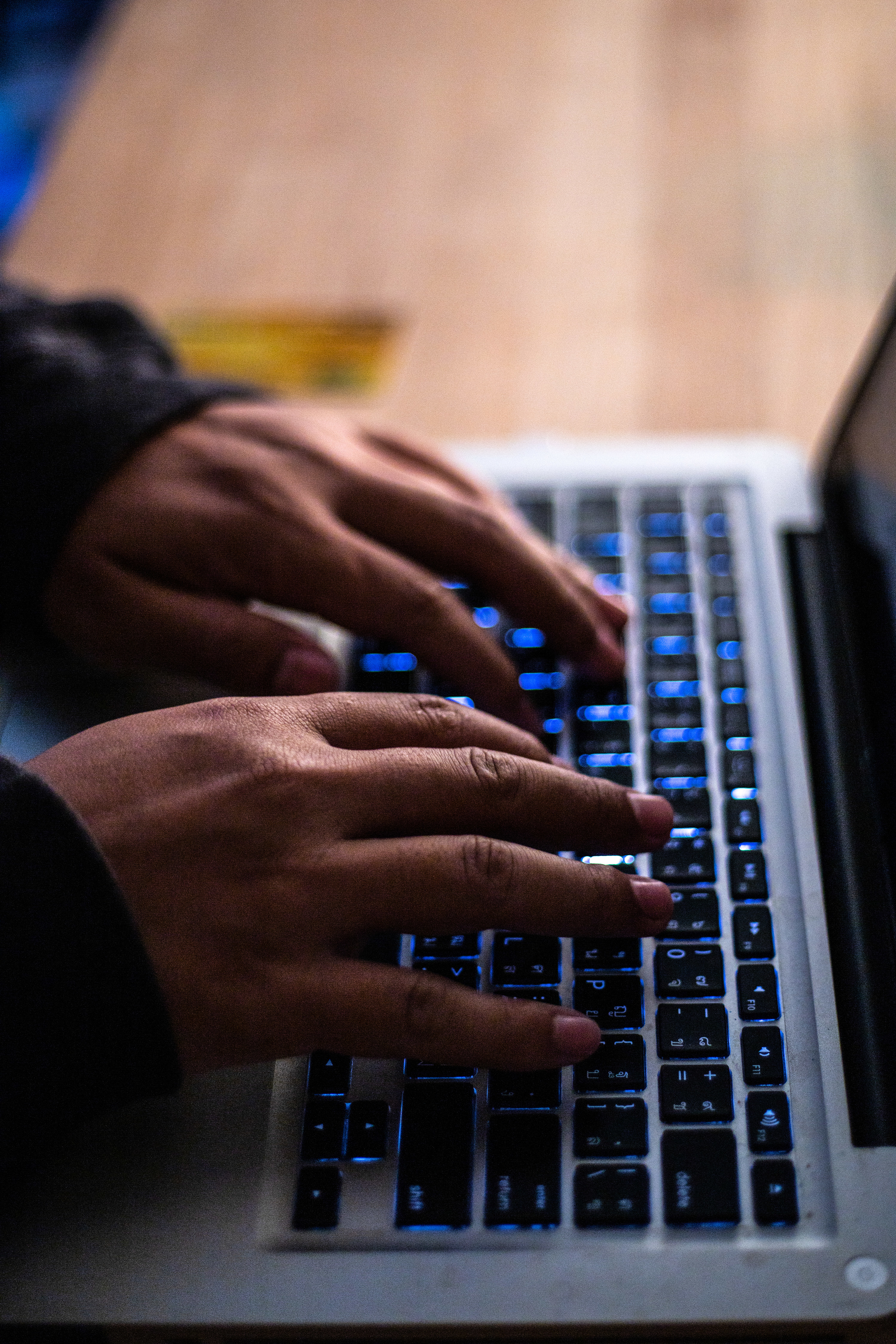 man typing on a laptop