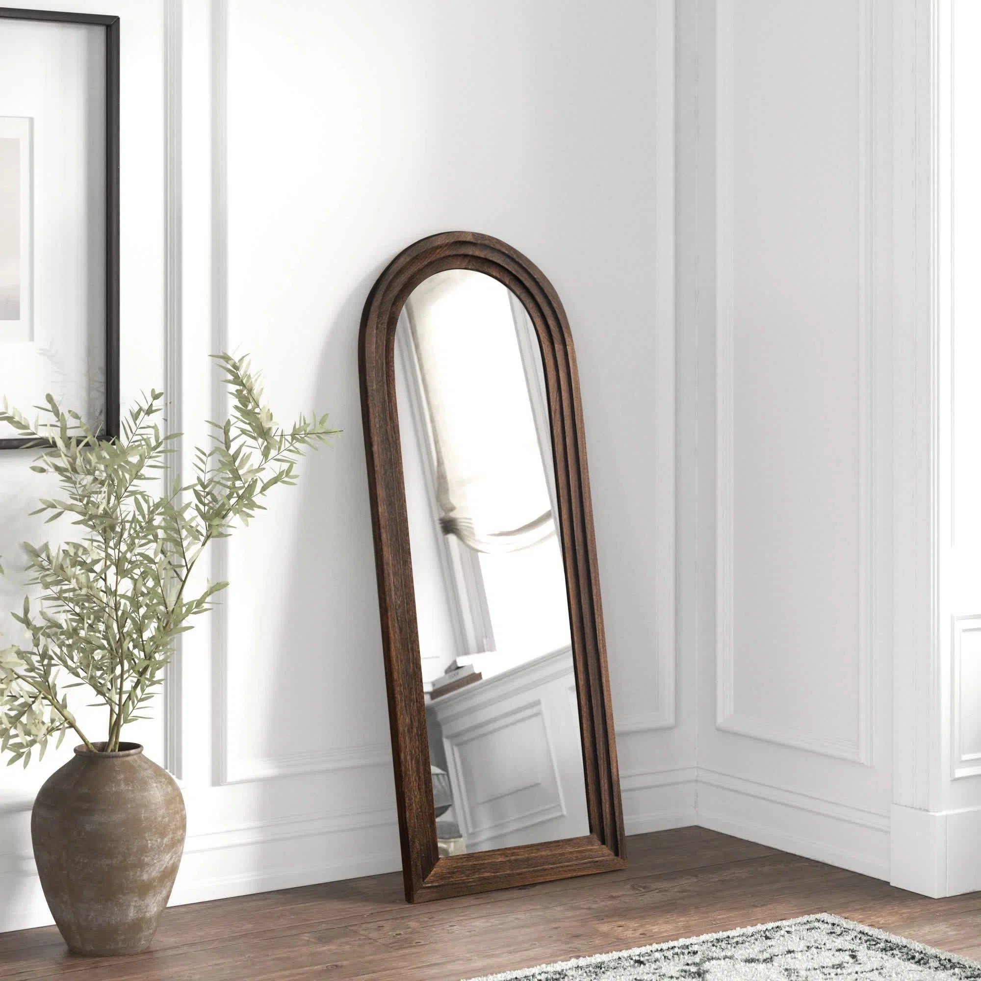 The arched mirror hanging against a wall