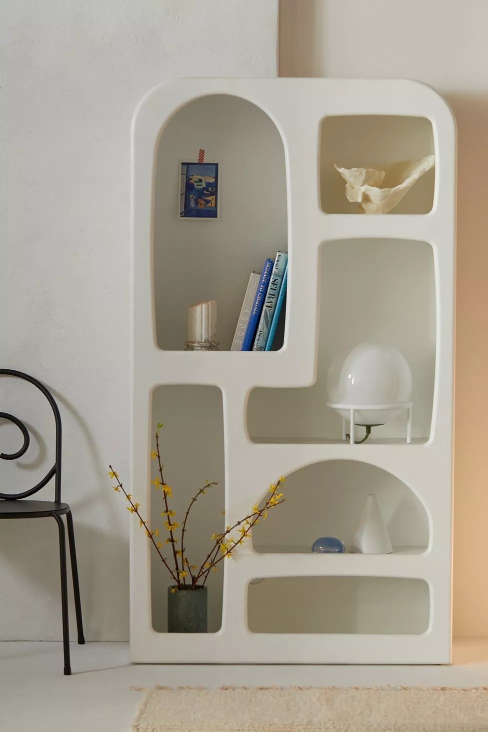the white bookshelf with books and other decor on it