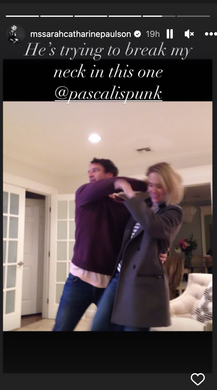 A screenshot from Sarah&#x27;s IG story of Pedro and Sarah pretend fighting, with caption &quot;He&#x27;s trying to break my neck in this one&quot;