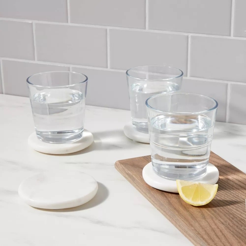 water glasses on white marble coasters