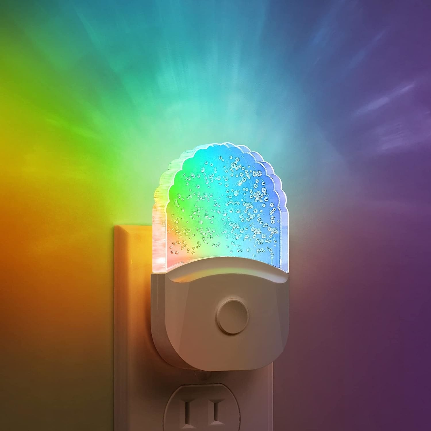 a rainbow nightlight plugged into an outlet