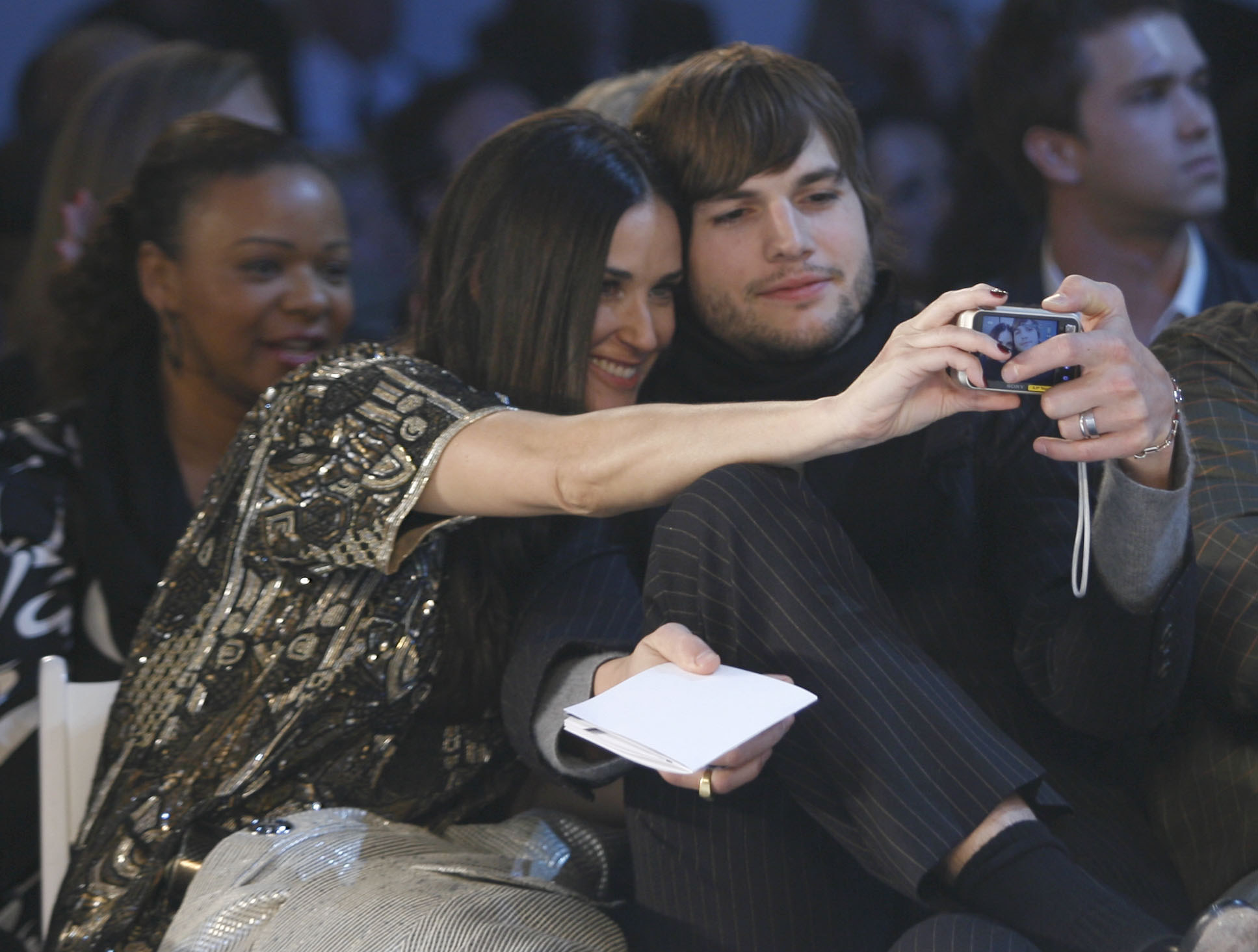 Demi Moore and Ashton Kutcher sit together and pose for a selfie