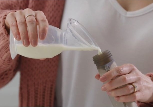Milk from the pump being poured into a container