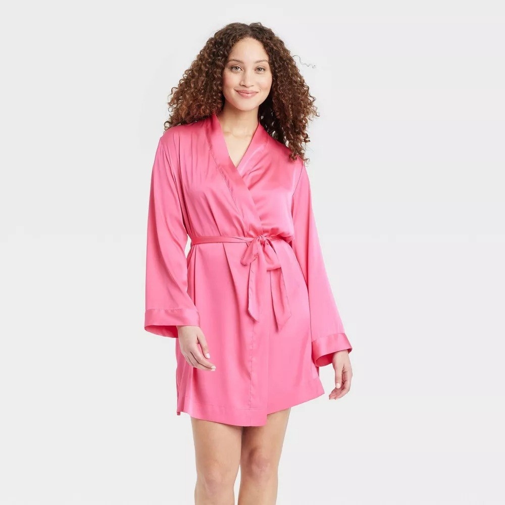 A model wearing the robe in pink