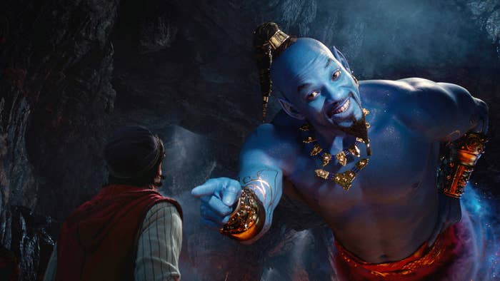 Will Smith as Genie pointing at Mena Massoud as Aladdin
