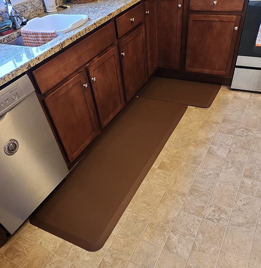 reviewer photo showing the cushioned mats in brown on their kitchen floor