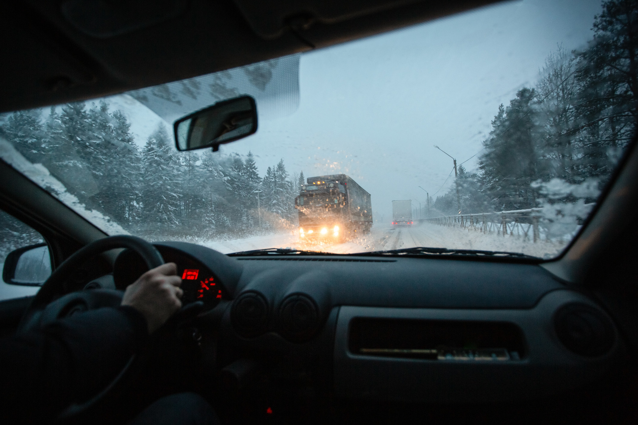 A person driving in a snowstorm