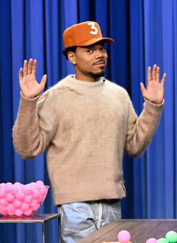 Chance the Rapper with his hands up