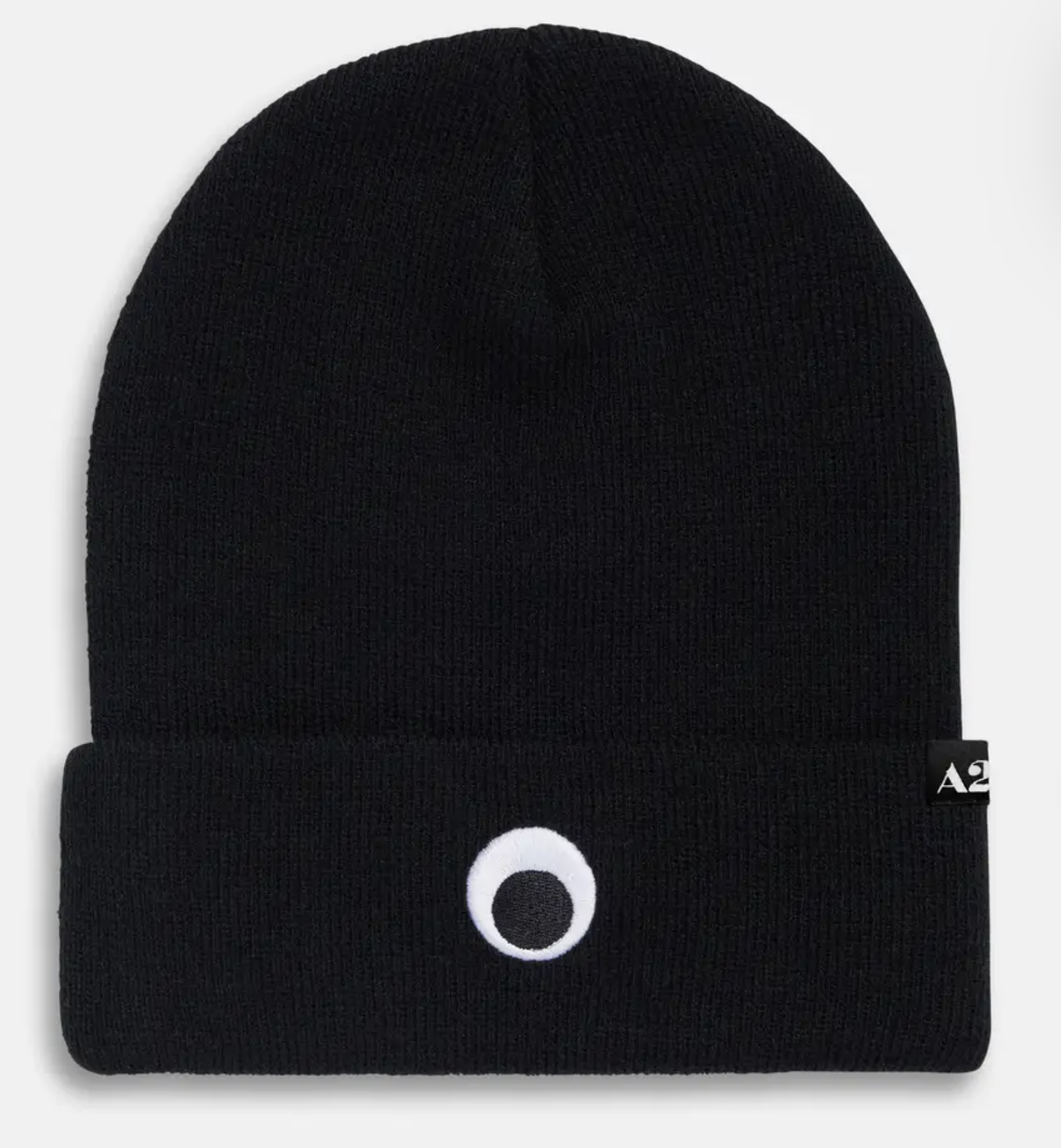 Black knit beanie with embroidered googly eye and woven A24 label.