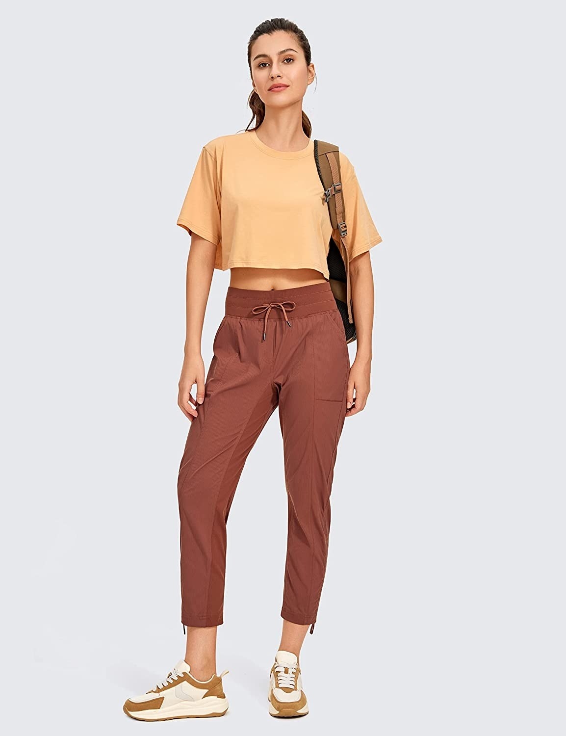 a model wearing the brown pants