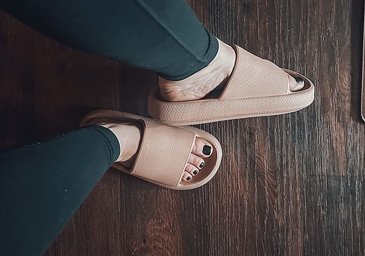 reviewer wearing the sandals in brown