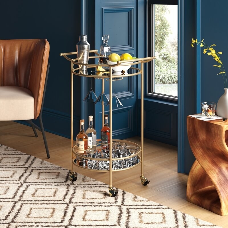the gold bar cart with a tray on top and bottom with wheels