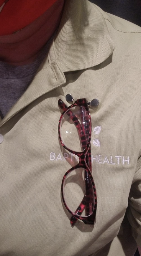 reviewer with magnetic eyeglass holder on shirt and glasses resting on the holder
