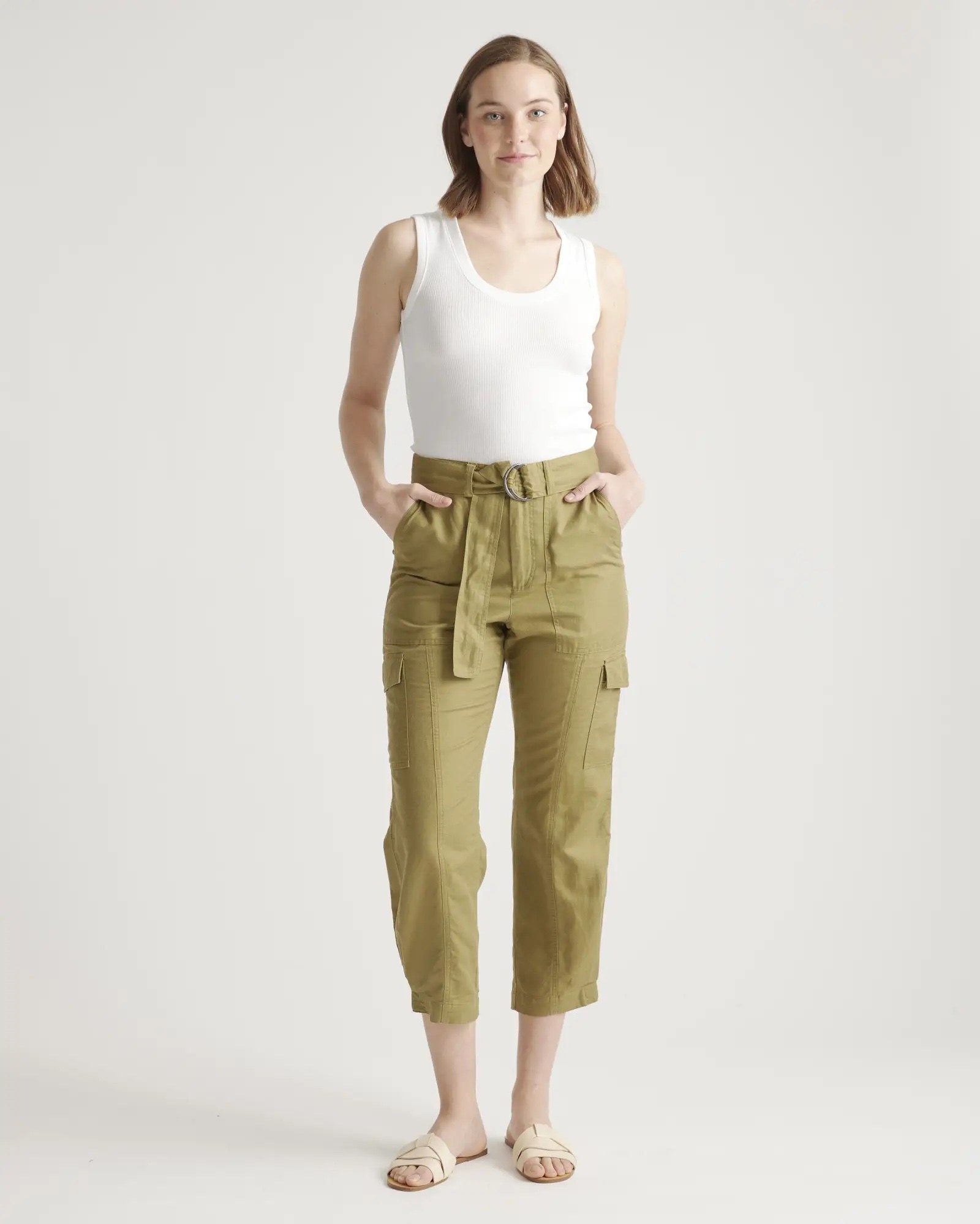 A white top with green pants and white shoes